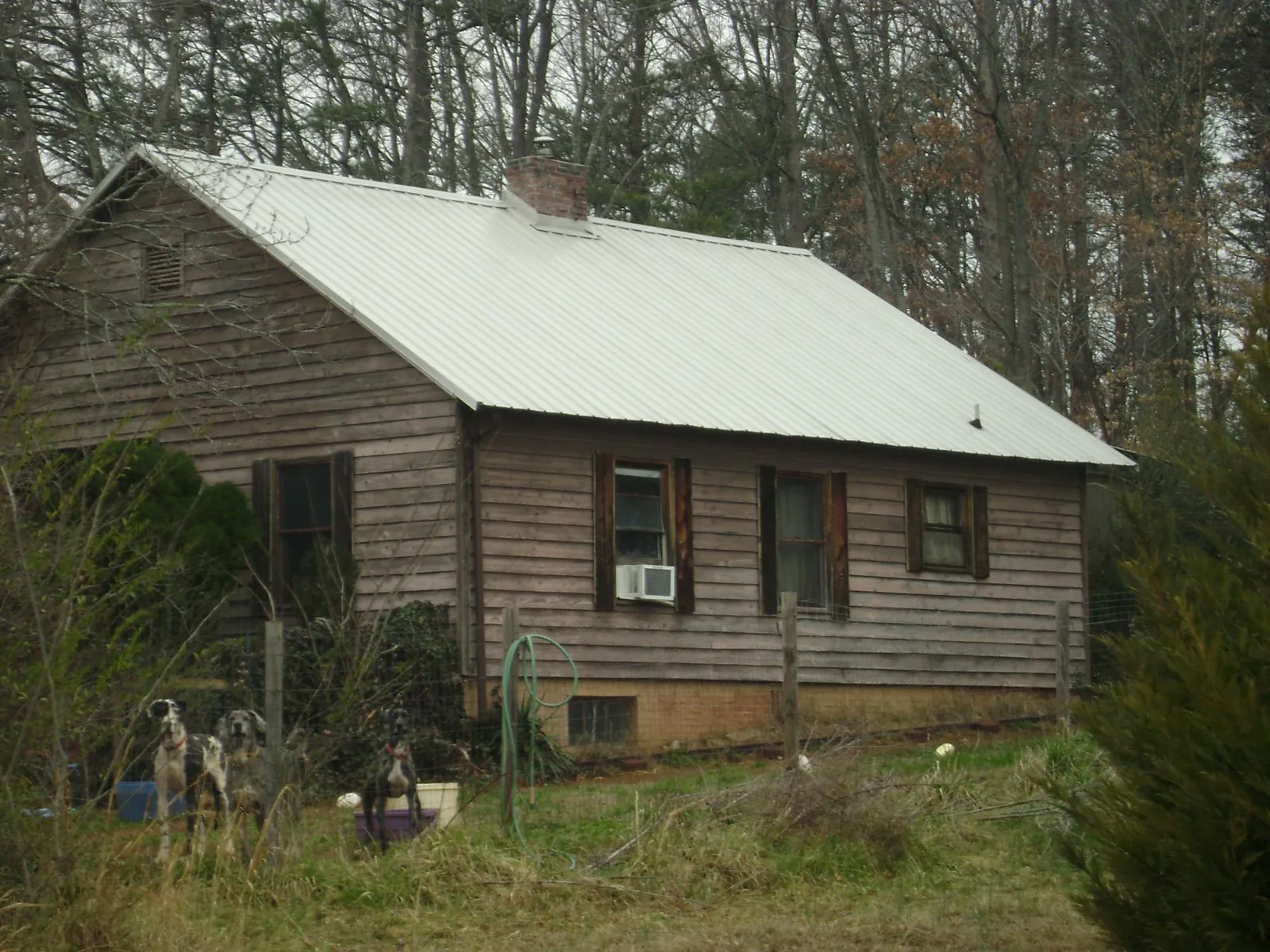 White metal roof on an old wood sided farmhouse, from a Metal Roof Installation job in Vinton